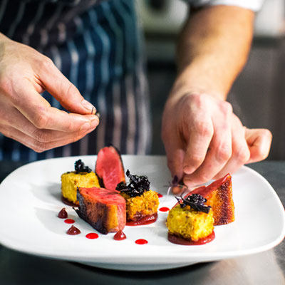 Plate of assorted food with chef in view